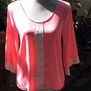 Pink blouse with lace trim on sleeves